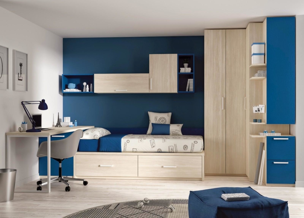 Cool-kids-room-interior-design-with-dark-blue-paint-wall-decor-and-natural-wooden-wardrobe-corner-and-simple-study-table-and-round-rug-on-laminate-floor